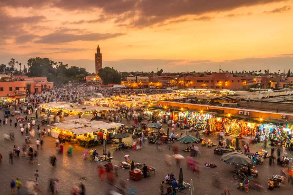 Sunset over Jemaa el-Fnaa square in Marrakech featuring the Koutoubia mosque, a key destination mentioned in our Morocco travel advisory guide.