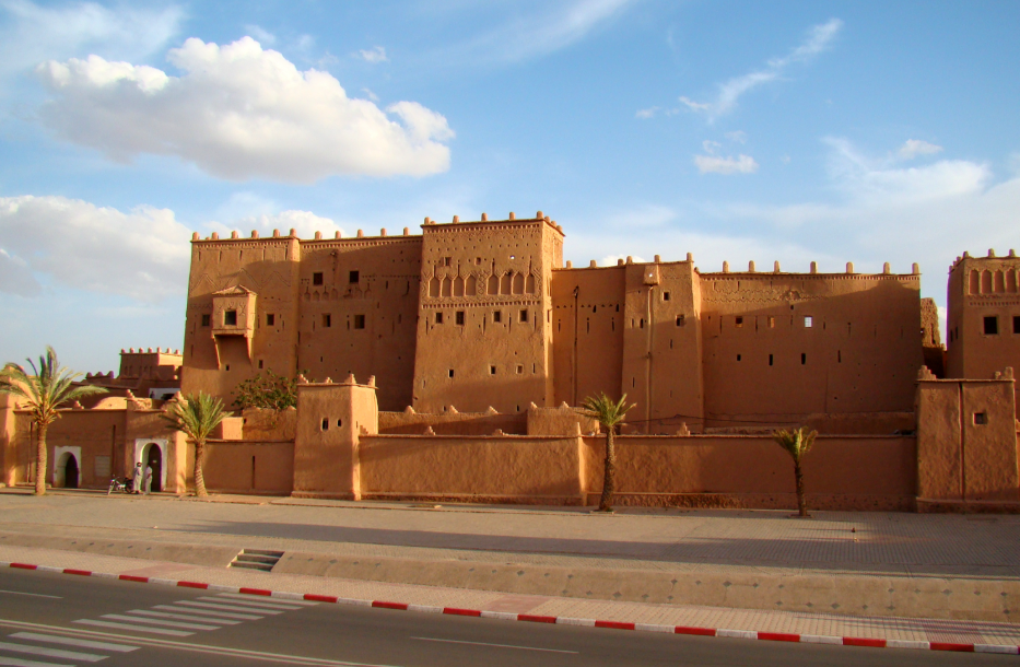 The ancient Taourirt Kasbah in Ouarzazate under a clear blue sky, a southern destination detailed in our Morocco travel advisory.